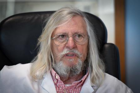 A picture taken on February 26, 2020 shows French professor Didier Raoult, biologist and professor of microbiology, specialized in infectious diseases and director of IHU Mediterranee Infection Institute posing in his office in Marseille, southeastern France. - Raoult reported this week that after treating 24 patients for six days with Plaquenil, the virus had disappeared in all but a quarter of them. The research has not yet been peer reviewed or published, and Raoult had come under fire by some scientists and officials in his native France for potentially raising false hopes. (Photo by GERARD JULIEN / AFP)