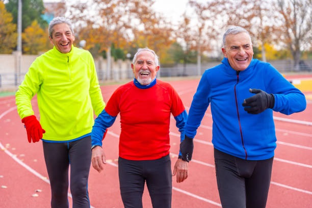 Tired senior men after running in an outdoor athletic track in winter